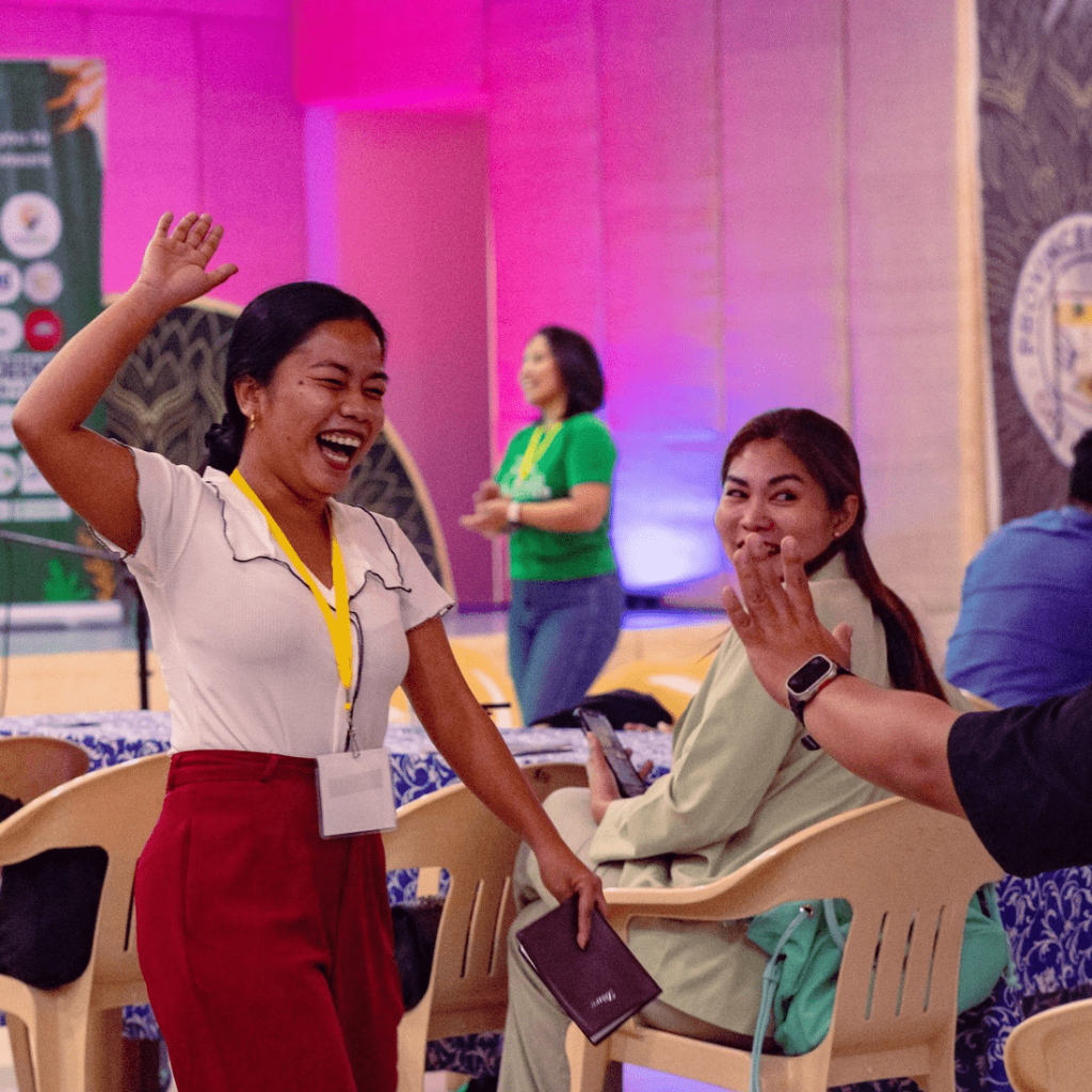 a participant joyously laughing at Startup Weekend Bohol Tourism Edition 2023